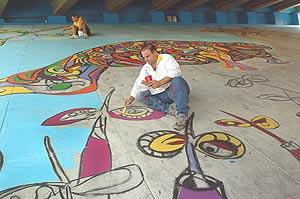 Local artist Xavier Cortada  painting underneath the I-395 overpass on Biscayne as part of the Miami Mangrove Forest.  NATALE E. PLANAS/HERALD STAFF